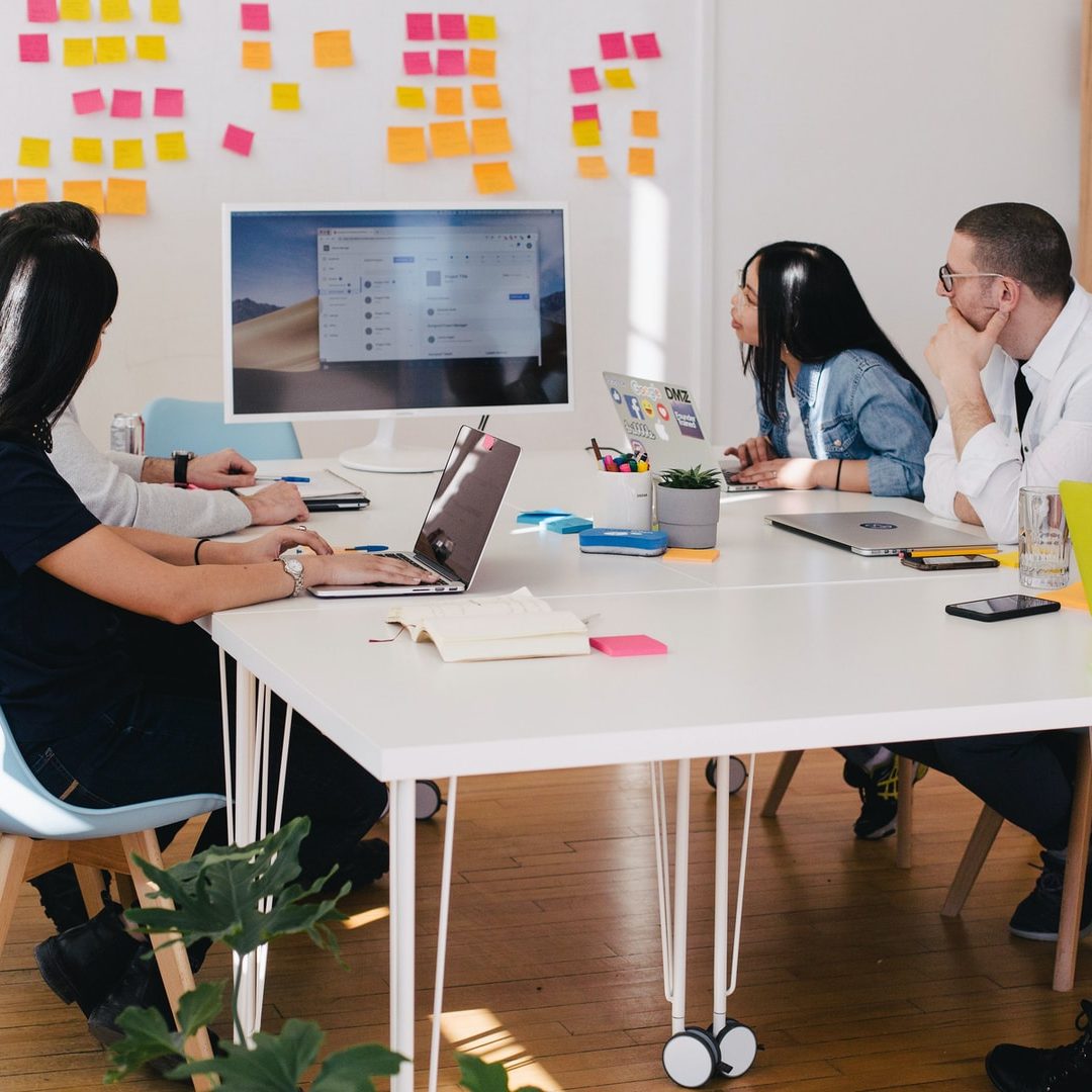 five person by table watching turned on white iMac
